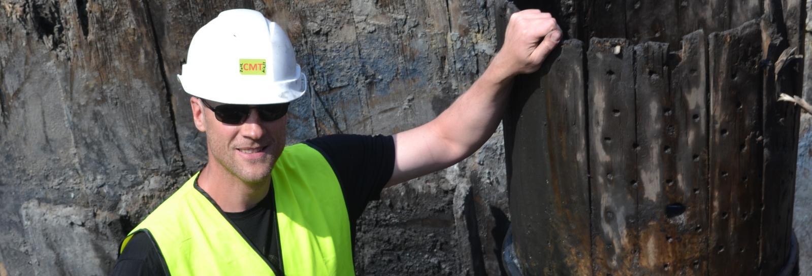 Glad arkæolog med tønde på havnekajen